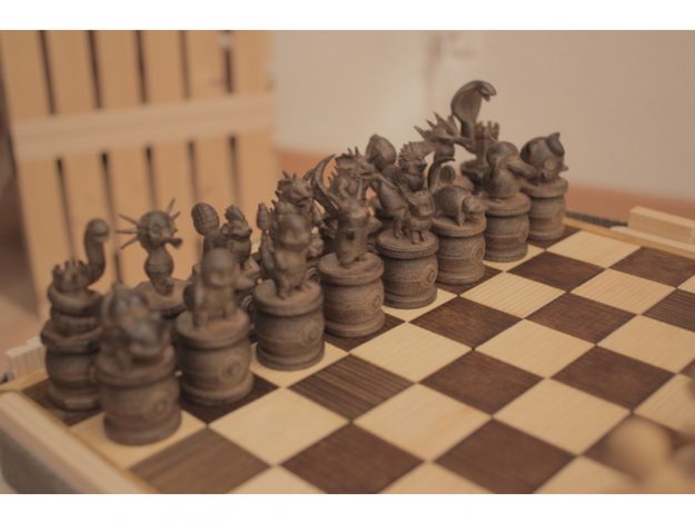 A set of dark Pokemon Chess pieces set on a chessboard