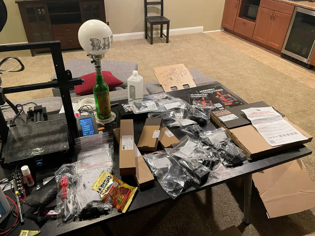 A table full of Prusa i3 MK3S+ parts, ready to assemble (it looks like a mess)
